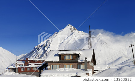 Hotels in winter snowy mountains at sun day 13563852