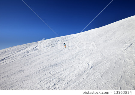 Skier on slope in sun day 13563854