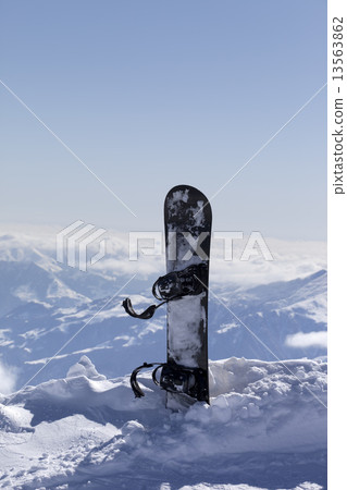 Snowboard in snow on off-piste slope at sun day Snowboard in snow on off-piste slope at sun day 13563862