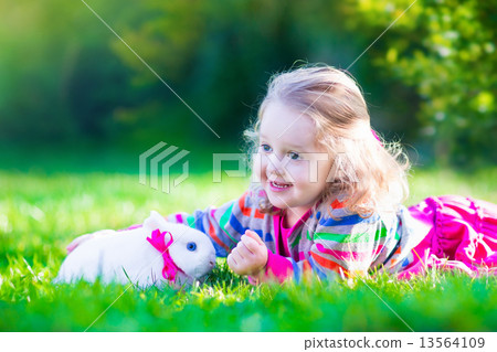 Little girl and real rabbit 13564109