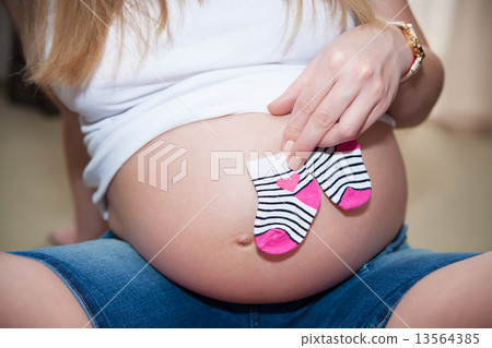 belly of pregnant woman with baby socks belly of pregnant woman with baby socks 13564385