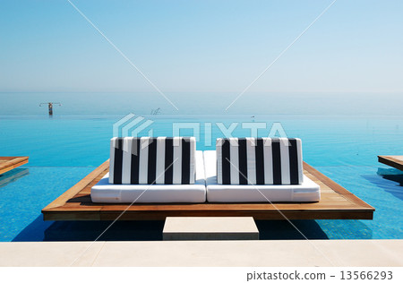 Infinity swimming pool by beach at the modern luxury hotel, Pier Infinity swimming pool by beach at the modern luxury hotel, Pier 13566293