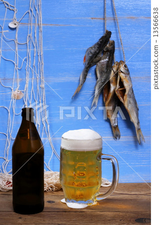 Beer on blue background, dried rudd fish Beer on blue background, dried rudd fish 13566638