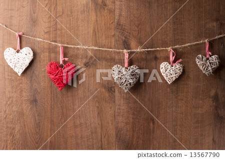 Hearts hanging on wooden wall 13567790
