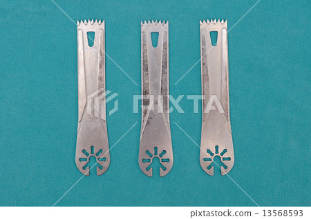 Surgery oscillating saw blades on green cloth. 13568593