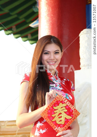 Woman in Cheongsam holding Chinese New Year Sign at Temple 13571007