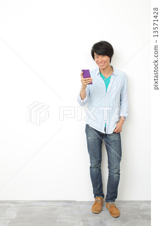 Male in twenties using a smartphone 13571428