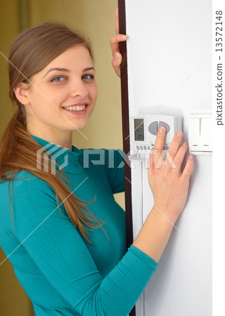 young hand with digital climate control young hand with digital climate control 13572148