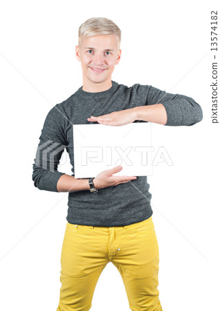 Smiling young casual man holding white sign  13574182