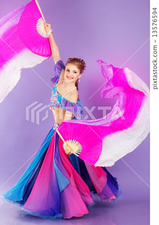 Beautiful belly dancer wearing a purple costume 13576594