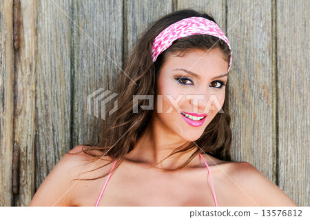 Attractive mixed woman with pink hair scarf 13576812