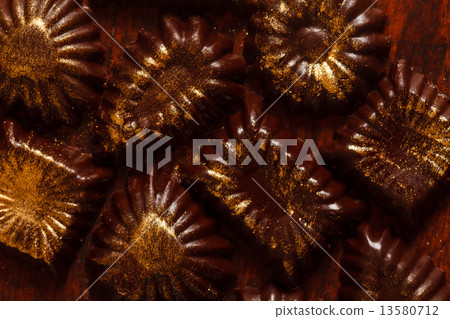 chocolate sweets with edible golden powder 13580712
