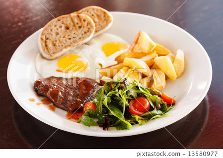steak with eggs and vegetables 13580977