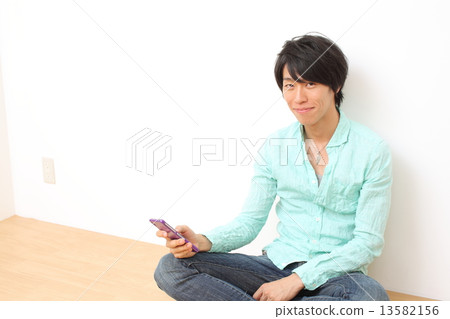 Male in twenties using mobile phone 13582156