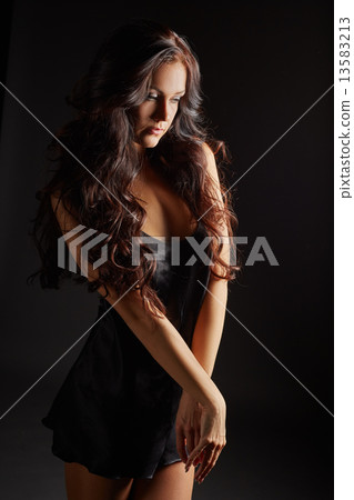 Beautiful tanned girl dressed in black negligee 13583213