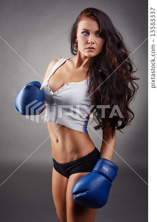 Studio shot of sexy girl in boxing gloves 13583337