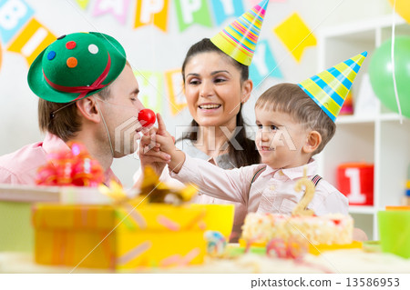 family playing on child birthday family playing on child birthday 13586953