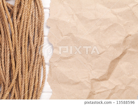 Brown rumpled cardboard paper background with marine rope 13588596