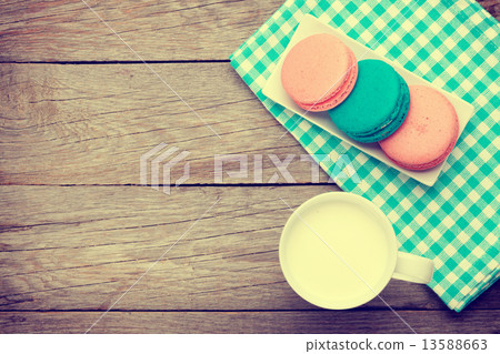 Colorful macaron cookies and cup of milk Colorful macaron cookies and cup of milk 13588663