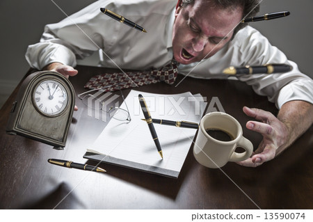Stressed Man At Desk, Pens, Coffee, Glasses, Clock Flying Up Stressed Man At Desk, Pens, Coffee, Glasses, Clock Flying Up 13590074