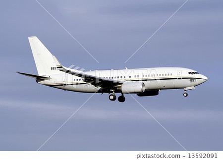 In the afternoon of fall, the US Navy's C-40A Clipper Transporter which flew the blue sky in a warm light 13592091