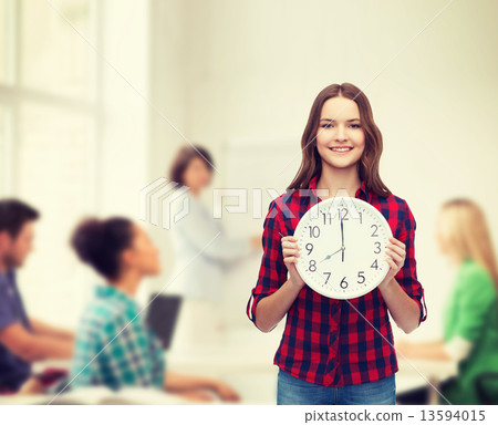 young woman in casual clothes with wall clock young woman in casual clothes with wall clock 13594015