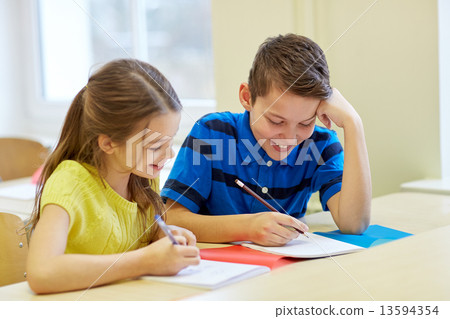 Stock Photo: group of school kids writing test in classroom