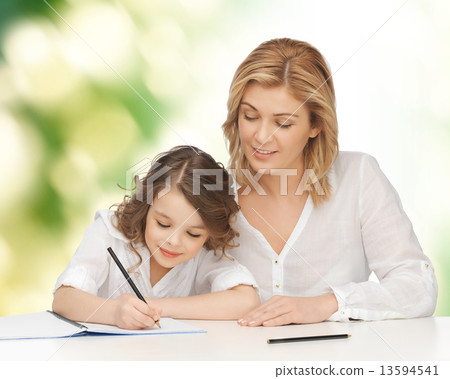 happy mother and daughter writing in notebook happy mother and daughter writing in notebook 13594541