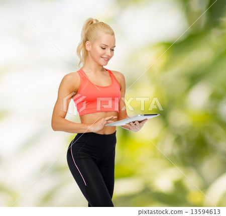 smiling sporty woman with tablet pc computer smiling sporty woman with tablet pc computer 13594613