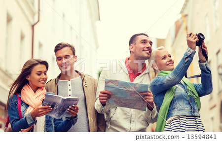 Stock Photo: group of friends with city guide, map and camera