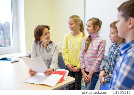 group of school kids with teacher in classroom group of school kids with teacher in classroom 13595115