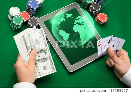 casino poker player with cards, tablet and chips 13595337