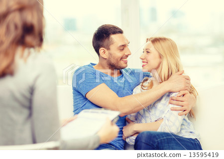 young couple hugging at psychologist office 13595419