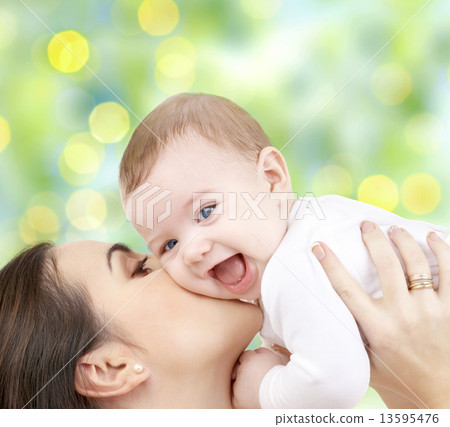 happy mother with baby over green background happy mother with baby over green background 13595476