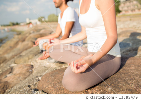 close up of couple making yoga exercises outdoors close up of couple making yoga exercises outdoors 13595479