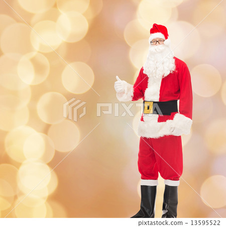 man in costume of santa claus showing thumbs up man in costume of santa claus showing thumbs up 13595522