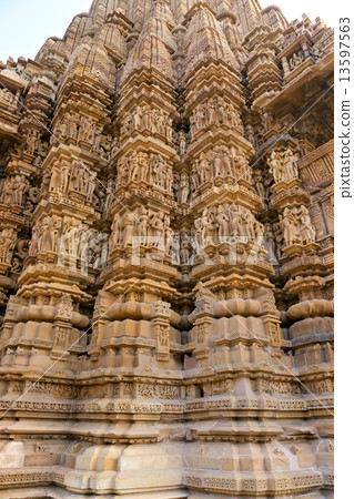 Kamasutra scene on the wall of a Temple in Khajuraho. 13597563