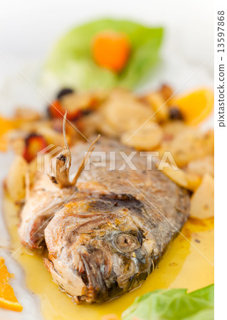 Fresh fish cooked with potatoes and tomatoes. Fresh fish cooked with potatoes and tomatoes. 13597868