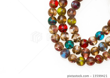 Close-up picture of a Mala made of colored glass. 13599421