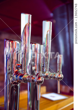 Shiny beer taps in a row 13602748