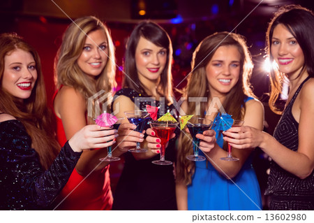 Pretty friends drinking cocktails together 13602980