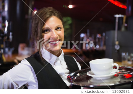 Happy barmaid holding tray with coffee 13602981