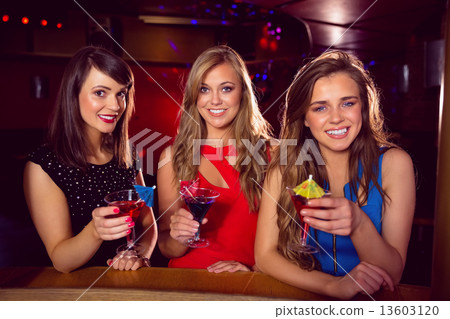 Pretty friends drinking cocktails together 13603120