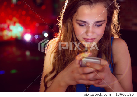 Pretty girl texting on her phone Pretty girl texting on her phone 13603189