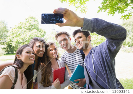 Happy students taking a selfie outside on campus 13603341