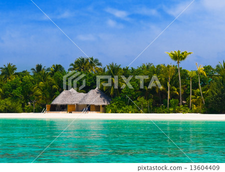 Bungalow on a tropical beach 13604409