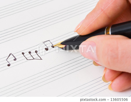 Hand with pen and music sheet Hand with pen and music sheet 13605506