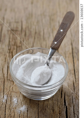Spoon of baking soda in bowl of baking soda Spoon of baking soda in bowl of baking soda 13608637