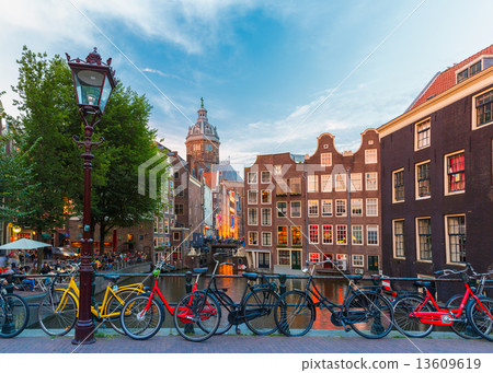 Night city view of Amsterdam canal, church and bridge 13609619
