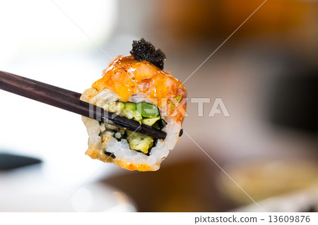 Sushi roll with black chopsticks Sushi roll with black chopsticks 13609876